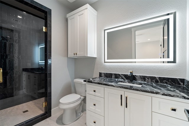 bathroom with walk in shower, vanity, and toilet