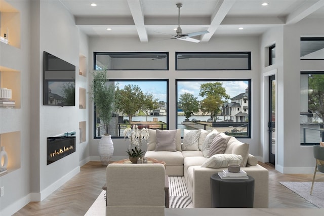 living room with ceiling fan, beam ceiling, light parquet floors, and coffered ceiling