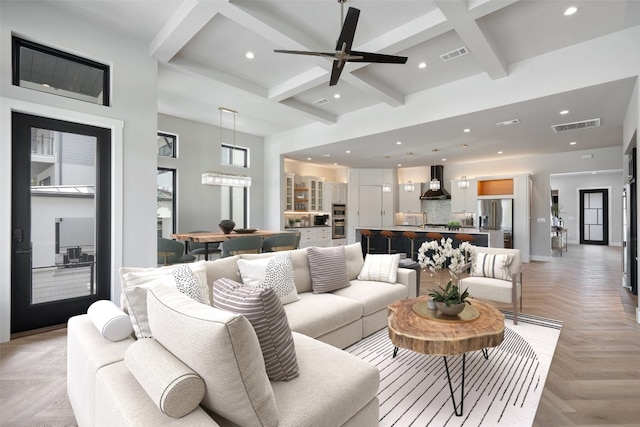 living room featuring light parquet floors, coffered ceiling, sink, beamed ceiling, and ceiling fan