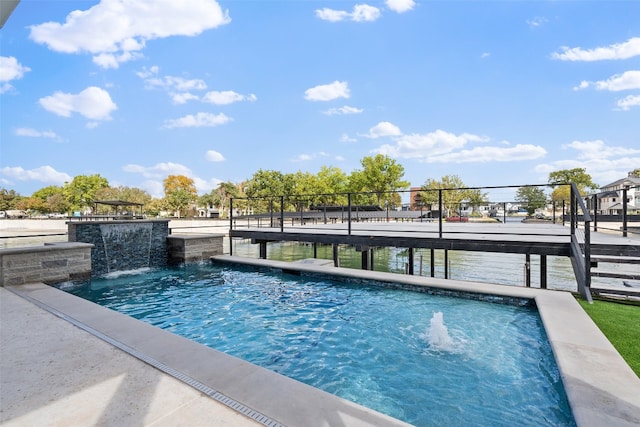 view of swimming pool with pool water feature