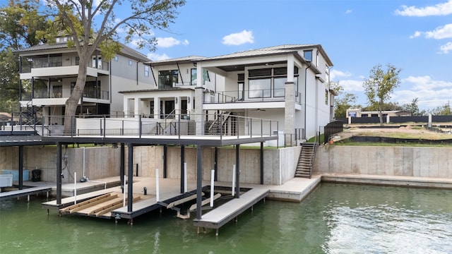 dock area featuring a water view and a balcony