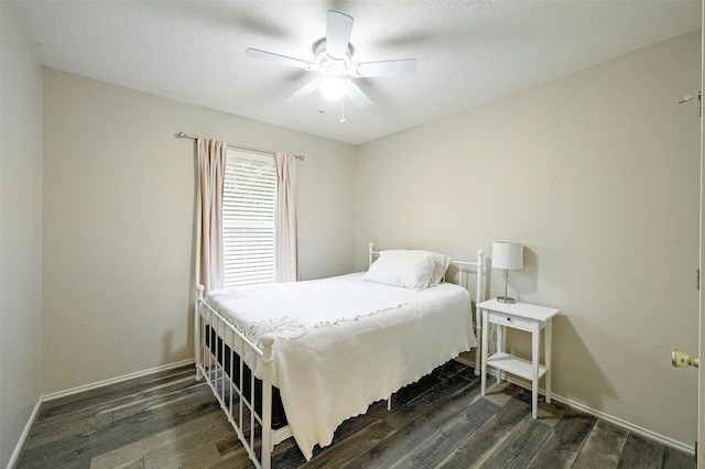 bedroom with dark hardwood / wood-style flooring and ceiling fan