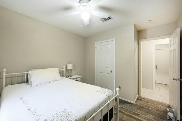 bedroom with dark hardwood / wood-style floors and ceiling fan