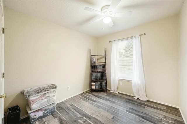 miscellaneous room featuring hardwood / wood-style flooring, ceiling fan, and a textured ceiling