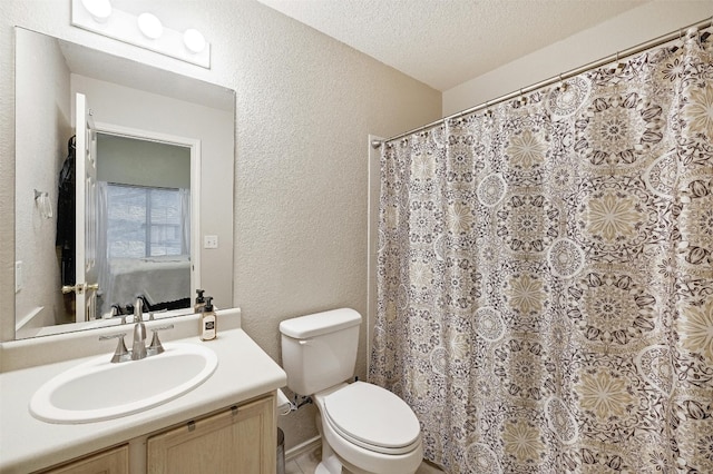 bathroom featuring vanity, toilet, a textured ceiling, and walk in shower