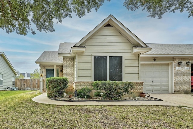 view of front of property featuring a garage and a front yard