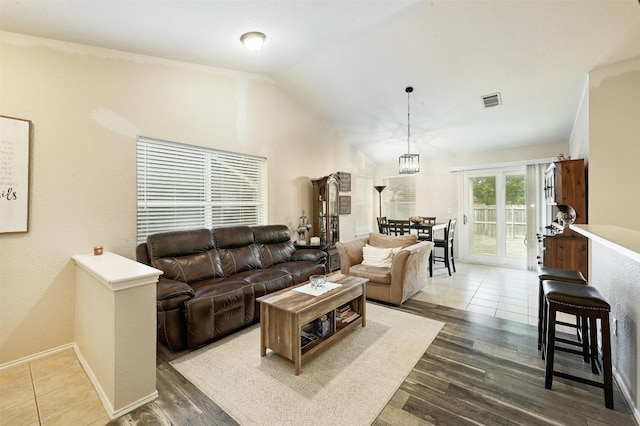 living room featuring lofted ceiling and dark hardwood / wood-style floors