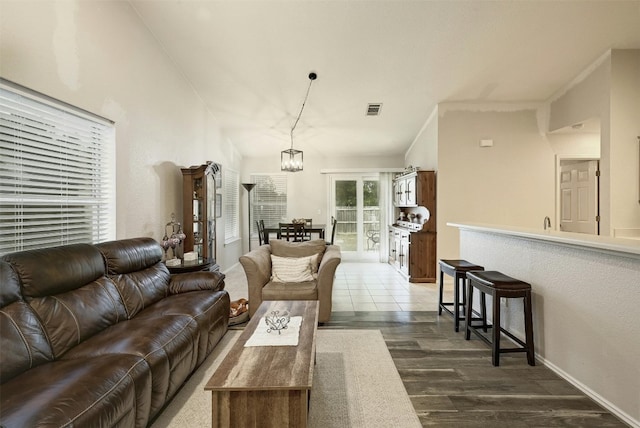 living room with dark wood-type flooring and a chandelier