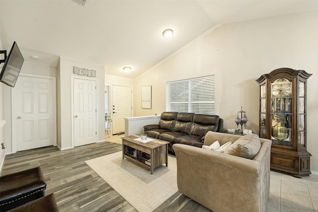 living room featuring hardwood / wood-style flooring and vaulted ceiling