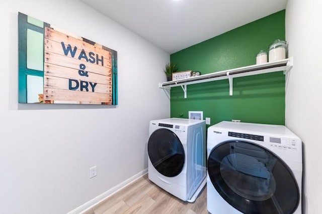 washroom featuring light wood-type flooring and washer and clothes dryer