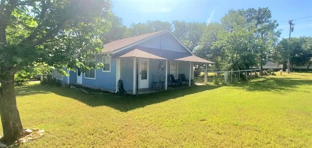 view of side of property with a yard