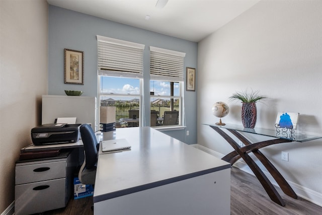 home office with dark hardwood / wood-style flooring