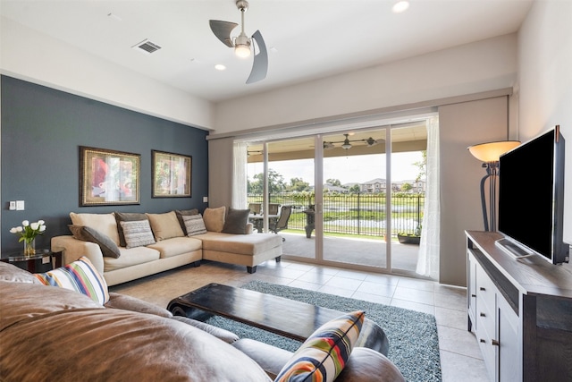 tiled living room with ceiling fan