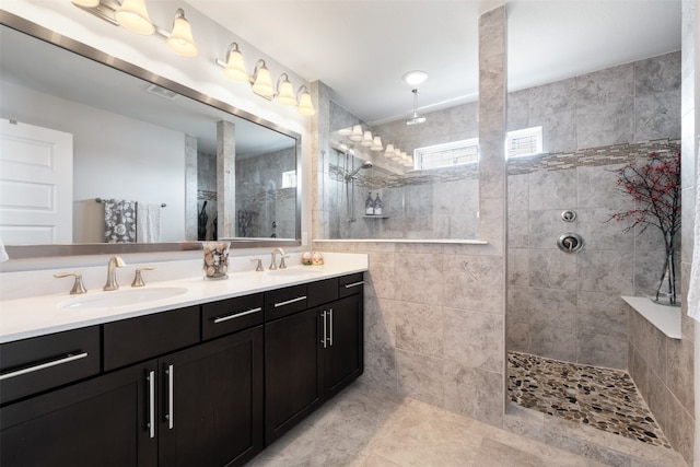 bathroom with vanity and tiled shower