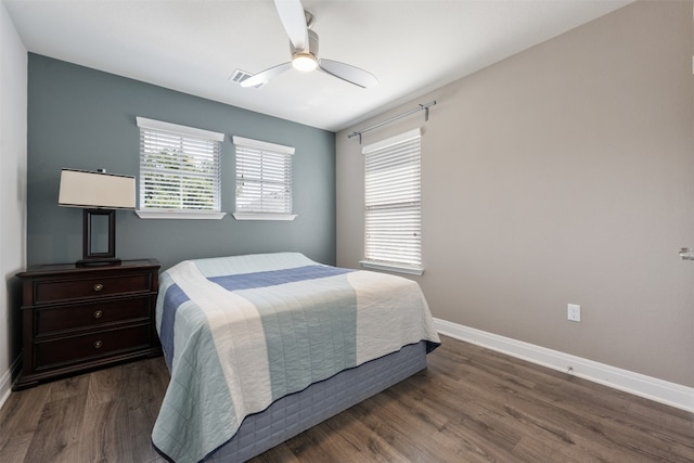 bedroom featuring dark hardwood / wood-style flooring and ceiling fan