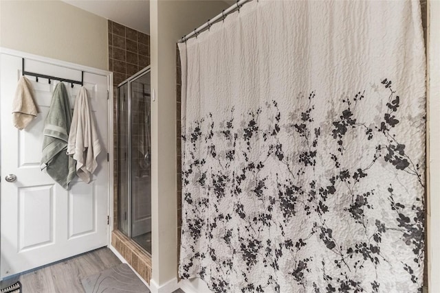 bathroom featuring tiled shower and hardwood / wood-style floors