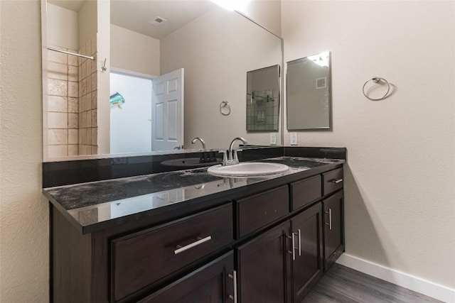 bathroom featuring vanity and hardwood / wood-style floors