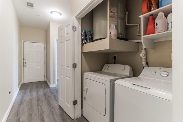 laundry room featuring washer and dryer and light wood-type flooring