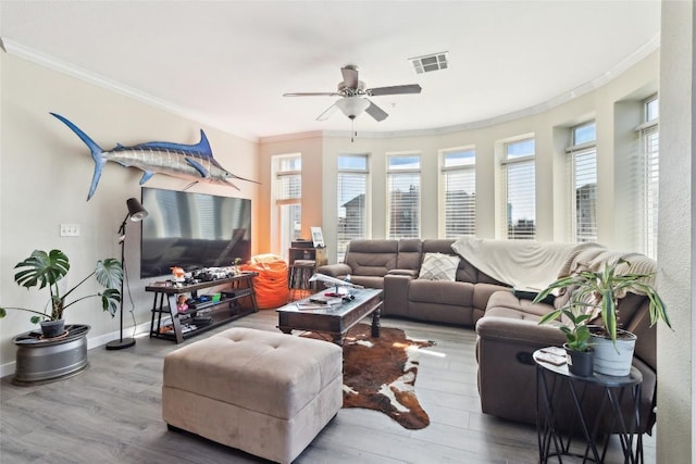 living room featuring hardwood / wood-style floors, ornamental molding, and ceiling fan