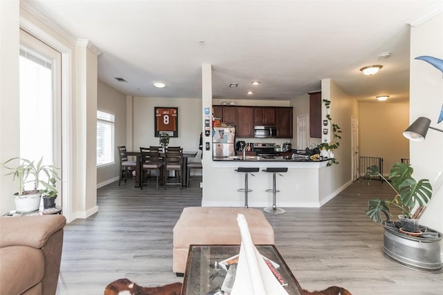 living room with sink and light wood-type flooring