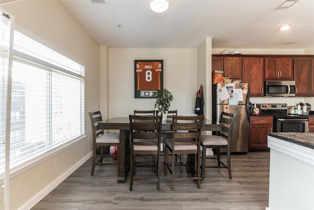 dining area featuring dark wood-type flooring