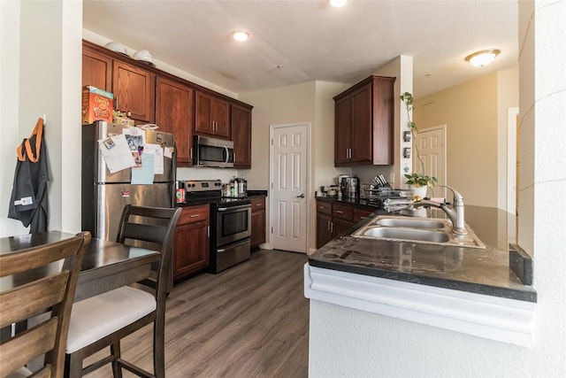 kitchen featuring dark wood-type flooring, appliances with stainless steel finishes, and sink