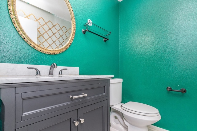 bathroom with toilet and vanity