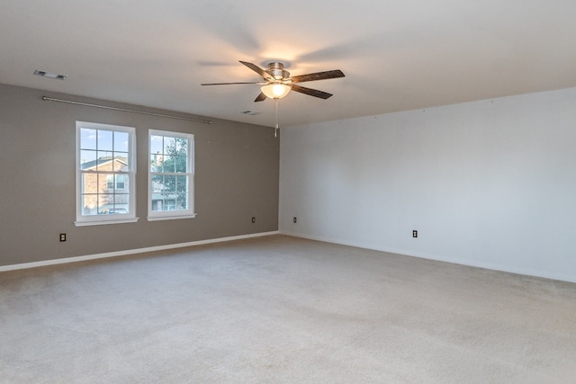 unfurnished room with ceiling fan and carpet