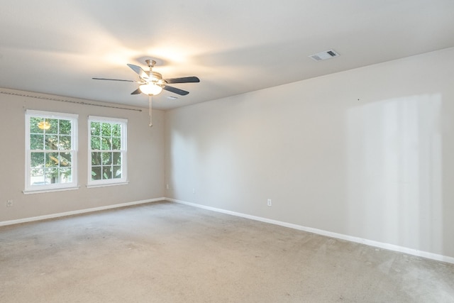 unfurnished room featuring light colored carpet and ceiling fan