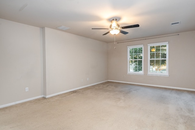 carpeted spare room with ceiling fan