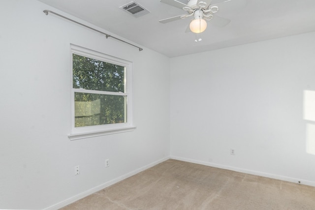 carpeted empty room featuring ceiling fan