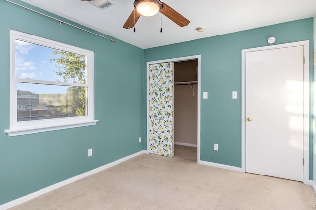 unfurnished bedroom featuring a closet, light carpet, and ceiling fan