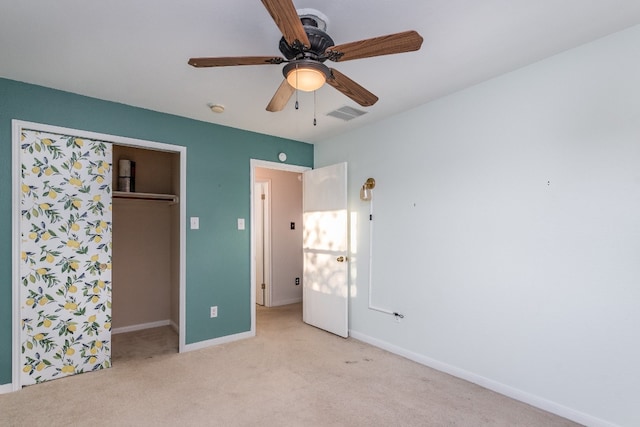 unfurnished bedroom with a closet, light carpet, and ceiling fan