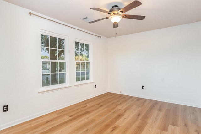 empty room with ceiling fan and light wood-type flooring