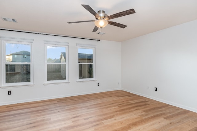 empty room featuring ceiling fan and light wood-type flooring