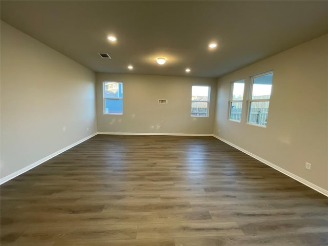 spare room featuring dark hardwood / wood-style flooring