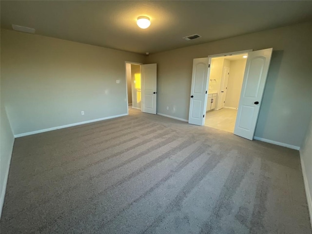 unfurnished bedroom with light colored carpet