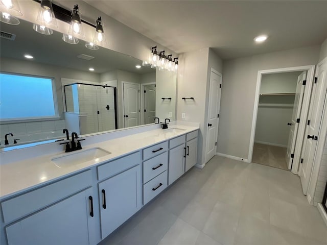 bathroom featuring vanity and a shower with door