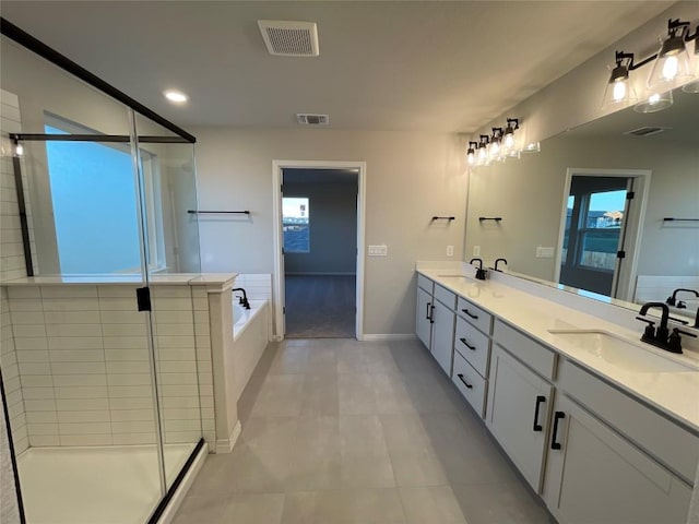 bathroom featuring tile patterned flooring, vanity, a wealth of natural light, and independent shower and bath