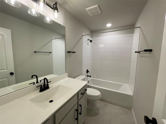 full bathroom with tile patterned floors, tiled shower / bath combo, toilet, and vanity