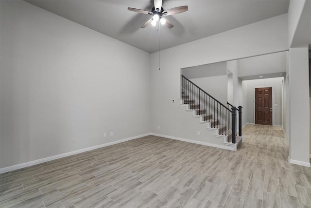 132 Scenic Hills Cir, Georgetown, TX 78628 - spare room with stairway, ceiling fan, light wood finished floors, and baseboards