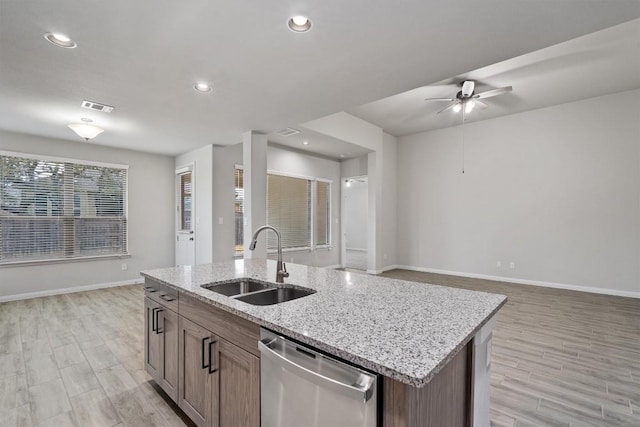 132 Scenic Hills Cir, Georgetown, TX 78628 - kitchen with dishwasher, a sink, baseboards, ceiling fan, and light wood finished floors