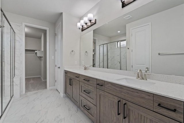132 Scenic Hills Cir, Georgetown, TX 78628 - bathroom with marble finish flooring, a marble finish shower, double vanity, a spacious closet, and baseboards