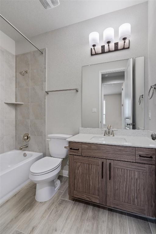 132 Scenic Hills Cir, Georgetown, TX 78628 - full bathroom featuring toilet, wood finished floors, shower / tub combination, and vanity