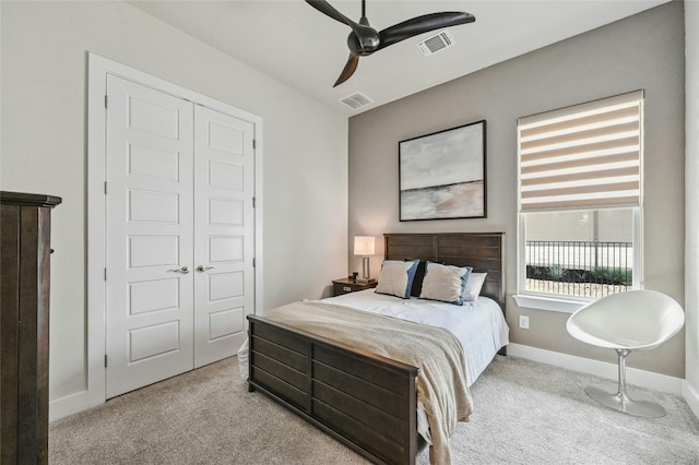 bedroom featuring ceiling fan, a closet, and light colored carpet