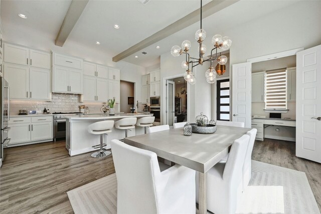 dining room featuring hardwood / wood-style flooring, beamed ceiling, and an inviting chandelier