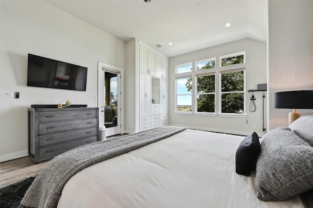 bedroom featuring wood-type flooring and vaulted ceiling