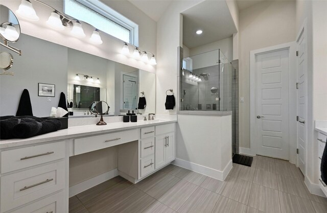 bathroom featuring vanity and tiled shower