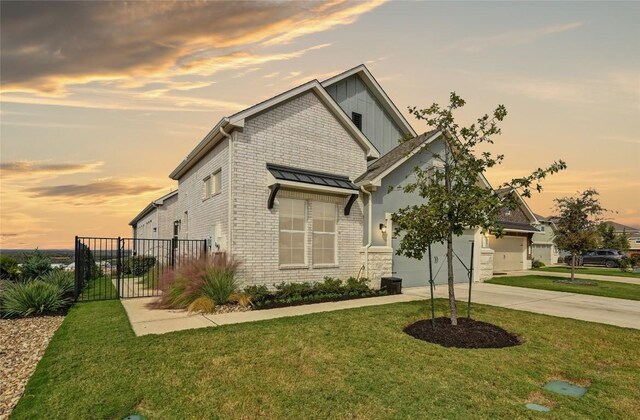 craftsman inspired home with a garage and a yard