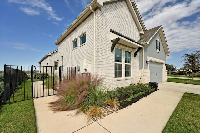 view of side of home featuring a garage and a yard